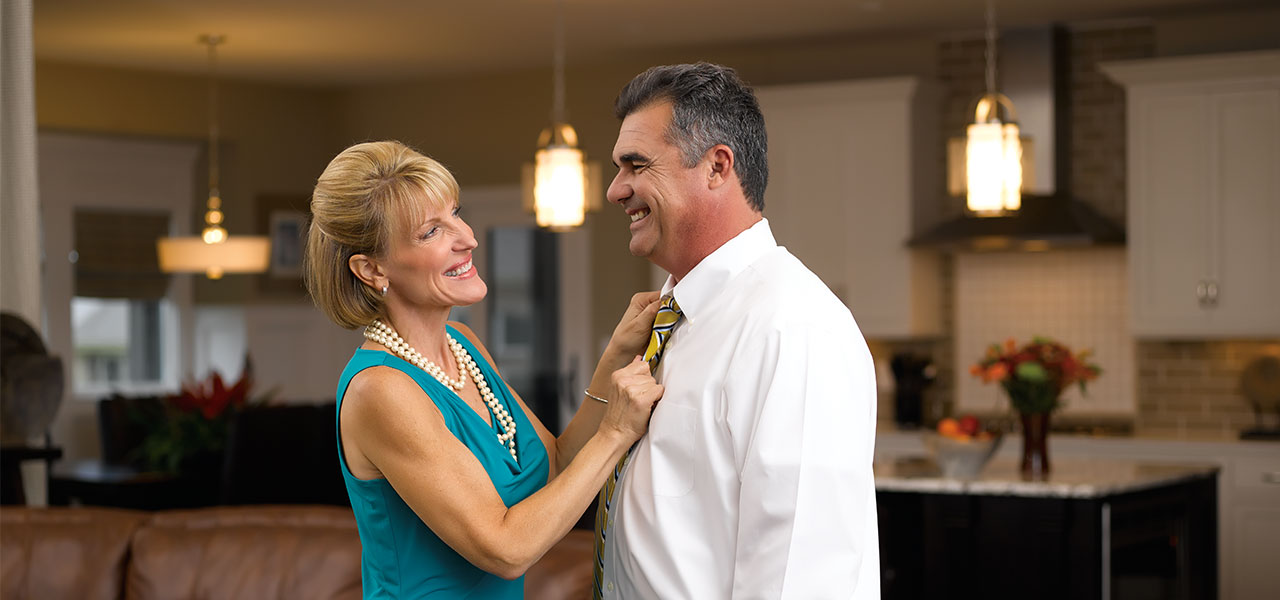 Woman fixing a man's tie